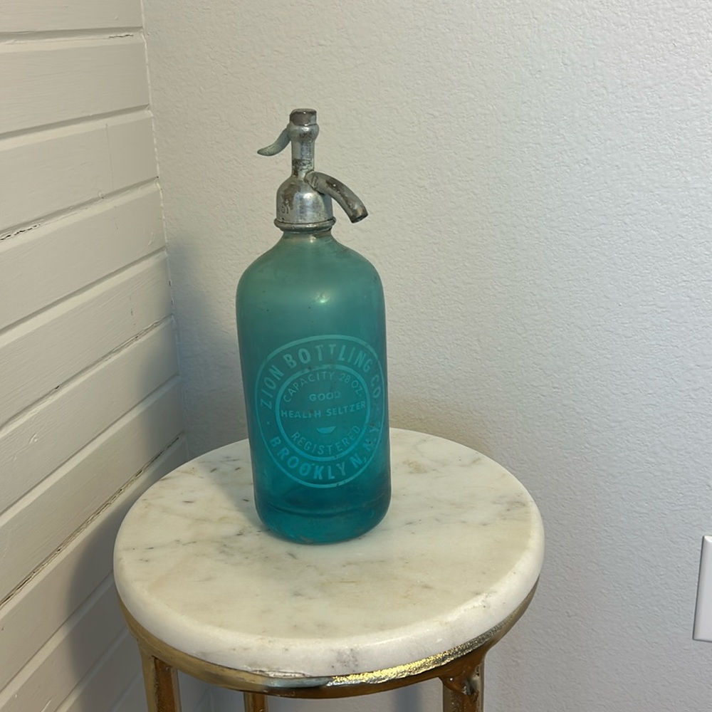 Two sided turquoise blue seltzer bottle 
Zion Bottling Co. & Kelly’s Beverages